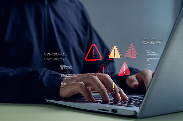 istock Cybersecurity concept showing hacker or IT professional typing on laptop with warning alert icons. Perfect for illustrating data breach, system error, or online security threat. 2248896074