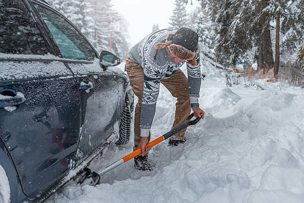 istock Clearing snow from a car stuck in a snowdrift using a shovel. 2248896939
