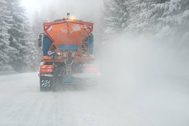 istock Snow plow clear and sprinkles snowy road in a snowstorm. 2248897103