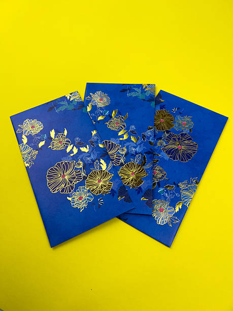 istock A blue envelopes with gold floral patterns arranged in a circular formation on a vibrant yellow background. A concept photo suits for Eid Fitr festive for Muslims around the world 2248900349