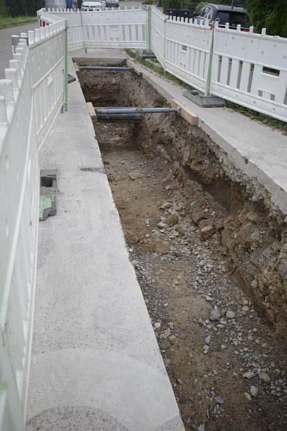 istock Open Trench with Temporary Fencing at Construction Site 2248902212
