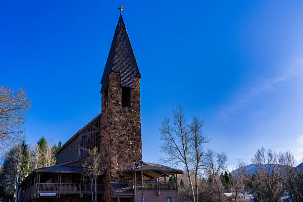 Aspen Chapel in Aspen, Colorado with snow-covered mountains in background on April 10, 2025.