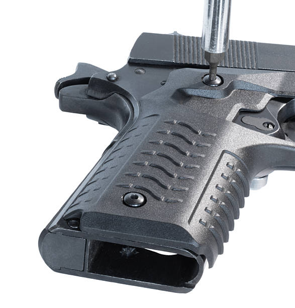 Tool tightening the second bolt on a handgun grip