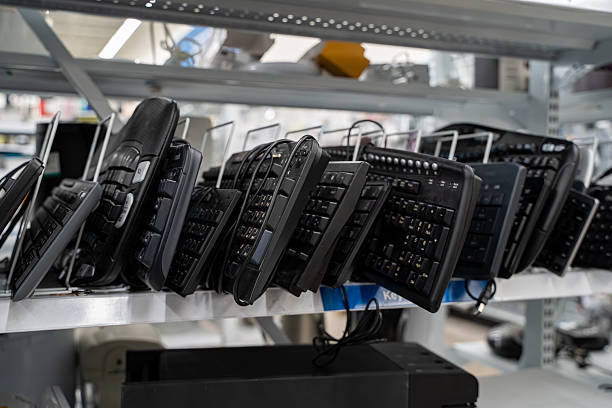 istock View of assorted used computer keyboards displayed on store shelf. 2248904927