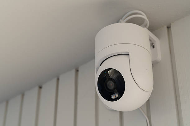 istock Modern white smart security camera mounted on a balcony ceiling for home surveillance and safety monitoring. 2248906911