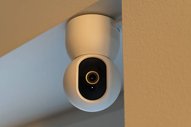 istock Modern white indoor smart home security camera mounted on a ceiling corner for safety and surveillance monitoring 2248906935