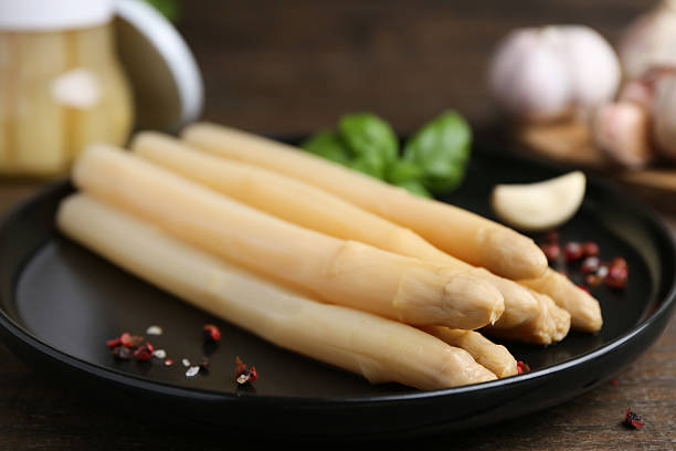 istock Pickled asparagus and spices on wooden table, closeup 2248906994