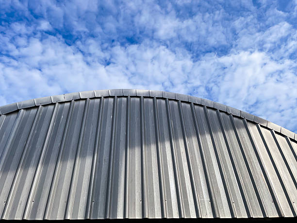 istock Curved Metal Roof Against Blue Sky 2248908022