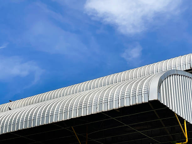 istock Curved Metal Roof Against Blue Sky 2248908058