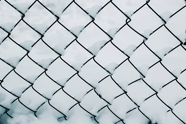 istock metal grid in snow background 2248908446