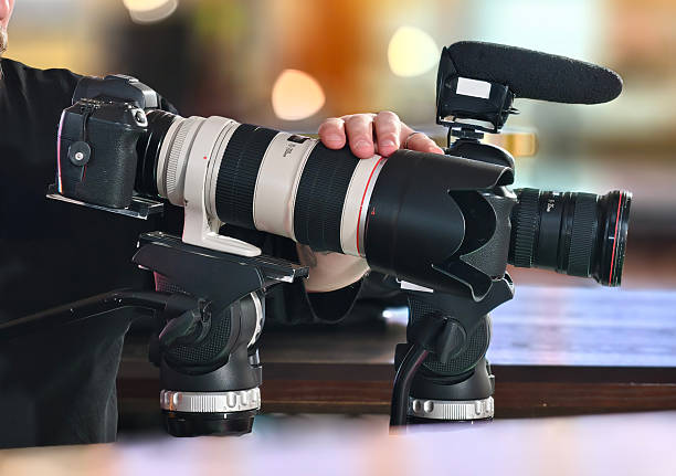 istock Professional videographer setting up camera equipment on a tripod 2248912085