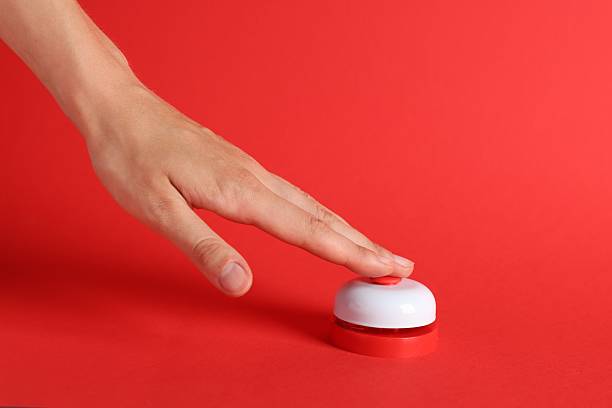 Woman pressing button on red background, closeup