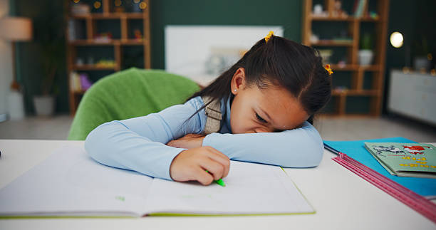 istock Tired, rest and child in bedroom with homework, fatigue or sleeping during problem solving at home. Burnout, learner and girl in house with notebook, nap and exhausted in homeschool assignment. 2248915156