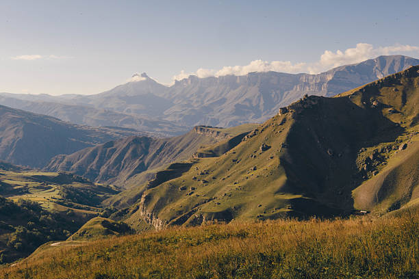 istock Mountain landscape with wide meadow in summer. sky with fluffy clouds on a sunny afternoon. green grass on the pasture rolling through hills in countryside scenery to distant Caucasus valley 2248917073