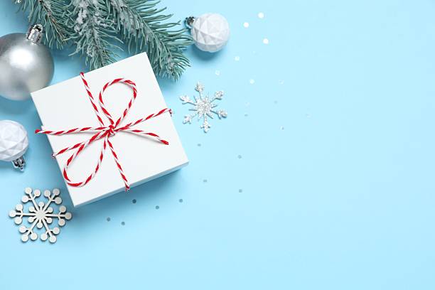 istock Christmas gift box and decorations on blue background,  seasonal greeting 2248918319