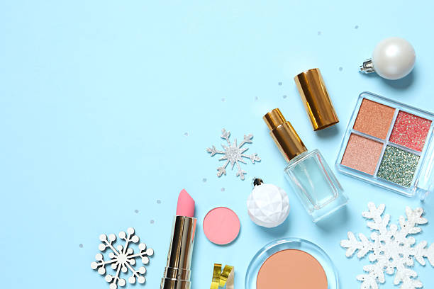 istock Flat lay composition with makeup products and Christmas decor on blue background 2248918526