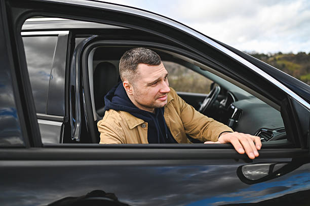istock Adult man relaxing in car, looking out window 2248919330