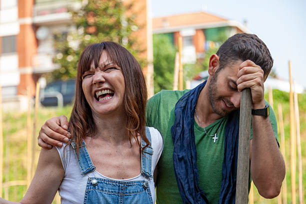 Couple sharing a moment of joy and togetherness outdoors in a home garden