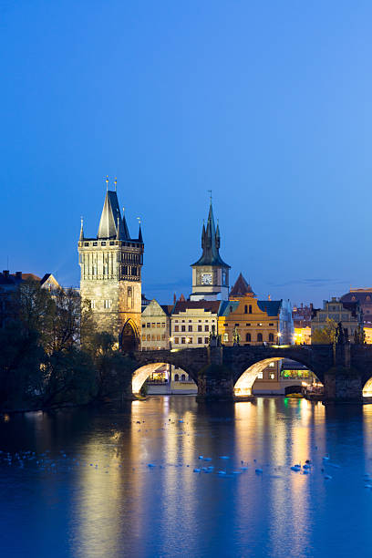 istock Charles bridge at blue hour glowing with historic architecture reflections on the vltava river, swans swimming near floodlit towers, a famous prague landmark after sunset 2248921887