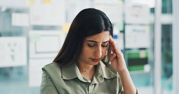 Business woman, web designer and headache with stress for project deadline, tasks or pressure. Frustrated, female person or developer with migraine or planning board for overworked, mistake or fail