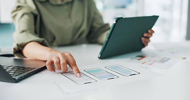 Woman, hands and web designer with, tablet, wireframes or mobile app for UX design in office. Female person, creative developer or pointing with technology, phone layout or blueprint for UI template