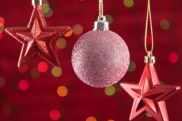 istock Hanging christmas ornaments on red background with bokeh lights. 2248923092