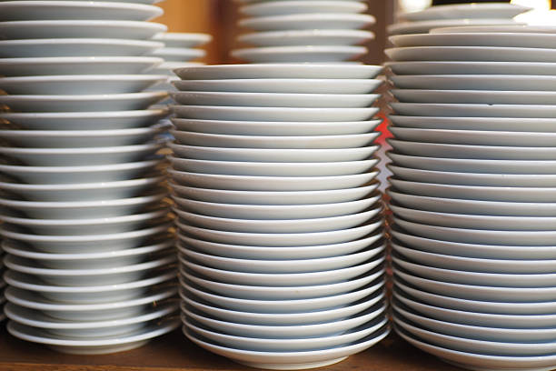 istock Stacked plates ready for serving in a busy kitchen 2248923692