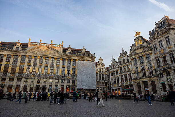 Belgium, Brussels-November 13,2025: Tourists gather and walk around Brussels Grand Place, the historic central square of Brussels, Belgium, known for its ornate guildhalls and vibrant city life.