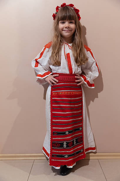 Portrait of a beautiful smiling girl in national Romanian red and white costume.