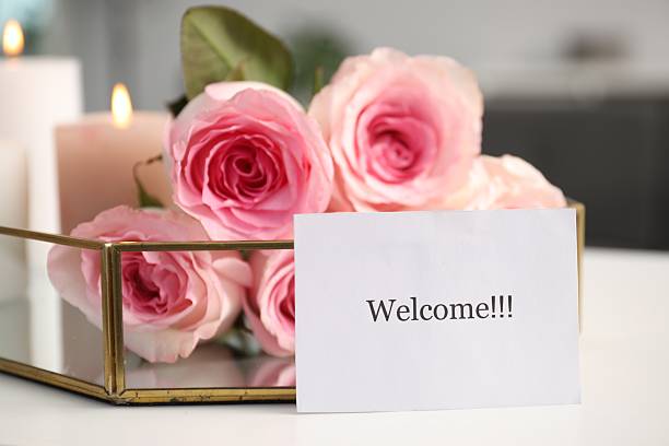 istock Card with word Welcome, roses and burning candles on white table, closeup 2248926842