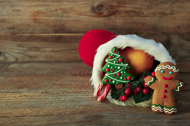 istock Saint Nicholas day tradition. Red boot with sweets and festive decor on wooden table, space for text 2248927103