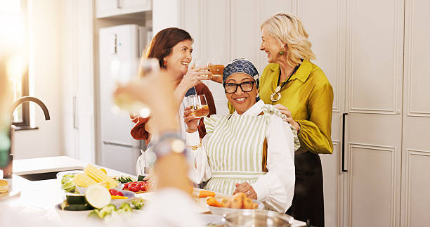 istock Cooking, kitchen and mature women with drinks for bonding, conversation and culinary lesson. Happy, social reunion and senior friends with cheers, toast and food for learning recipes together in home 2248927736