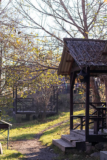 istock Wooden gazebos in autumn park with path and trees 2248928963