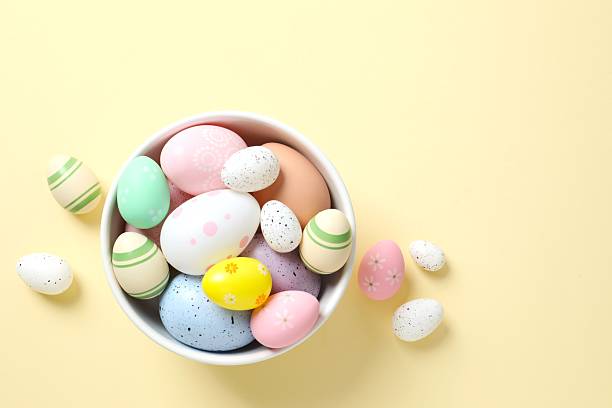 istock Happy Easter. Colorful eggs in a bowl on color background, space for text or advertising 2248930460