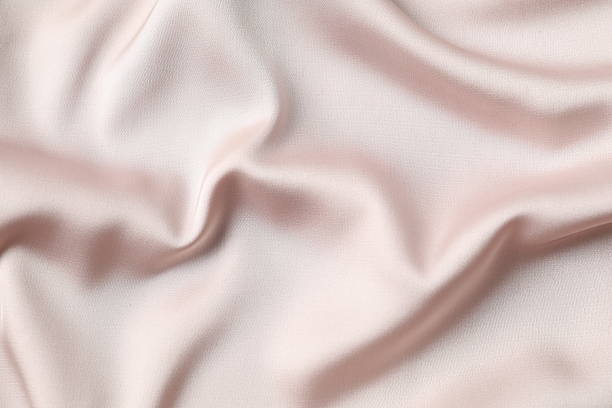 istock Beige silk satin. Shiny smooth fabric. Soft folds. Luxury background with space for design. Flat table, top view 2248930686