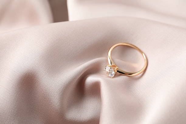 istock Beautiful engagement ring on silk fabric 2248930767