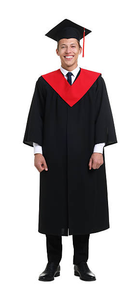 istock Young man in graduation gown and mortarboard on white background 2248930889