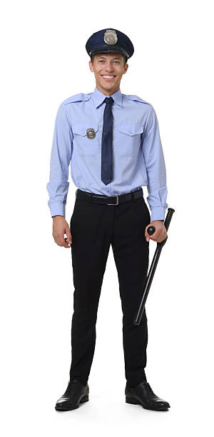 istock Young policeman in uniform with baton isolated on white 2248930944