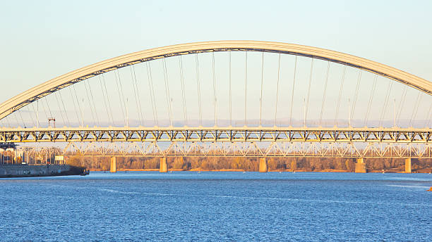 istock Clear evening view of a large arch bridge spanning a river with calm water reflections 2248931323