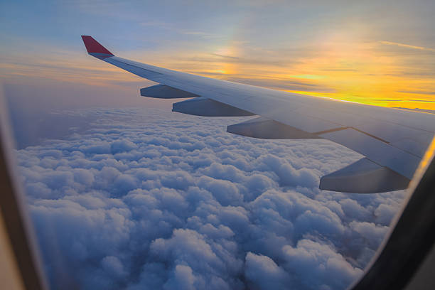 istock Airplane Wing View Above the Clouds During a Vibrant Sunset in Flight 2248931470