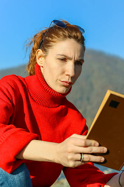 A portrait of a smiling 52 year old woman outdoors with lots of room for copy.