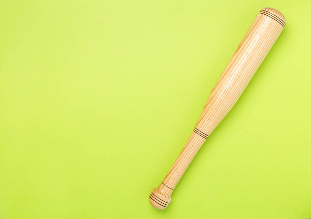 Wooden baseball bat on color background, top view