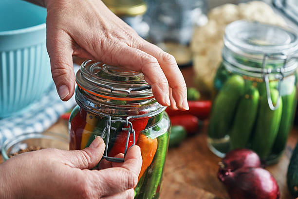 Fermented Foods - Preparing Fermented Mixed Chili Peppers with Spices and Filled in a Jar