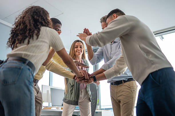 istock Diverse Executives Engaging in Team Huddle at Modern Office 2248939199