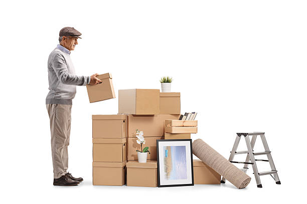 istock Senior man puttinging a box in a pile, home removal concept 2248939431