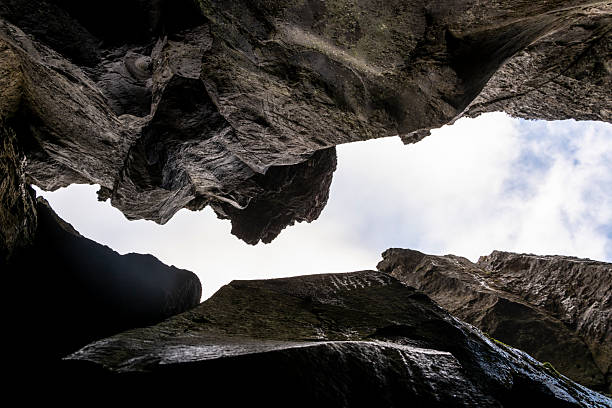 View from the cave to the blue sky and clouds. Rock formation.