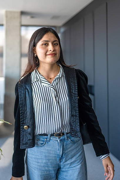 istock Confident Young Hispanic Woman Strolling Through Office Hallway 2248940738