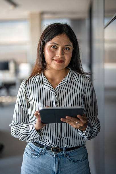 istock Young Hispanic Woman Confidently Holding Tablet in Office 2248940783