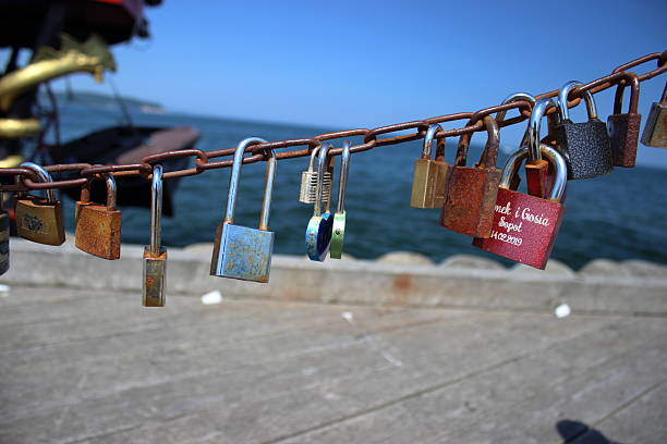 Rusty metal chain with colorful love locks hanging above the sea at the Sopot pier, Poland. Photo taken on June 5, 2019. Editorial use only.