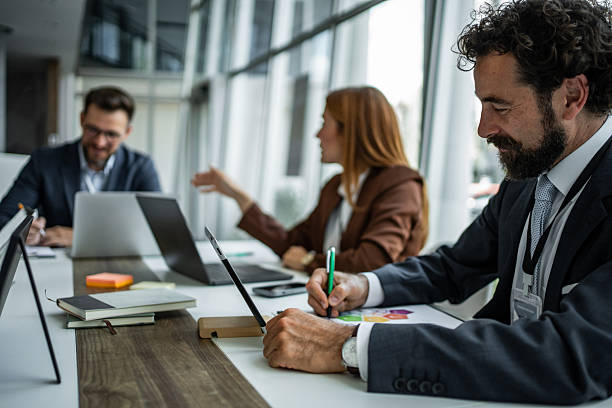 istock Business professionals collaborating and planning during office meeting 2248944735